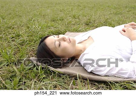 Close-up of a young woman sleeping on a mat View Large Photo Image Stock Image - Close-up of a young woman sleeping on a mat. Fotosearch