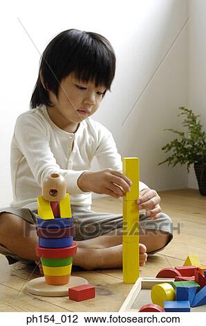 Stock Image - Girl playing with blocks. Fotosearch