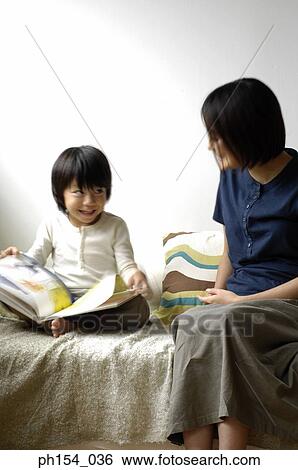 Stock Photograph - Mid adult woman teaching her daughter. Fotosearch