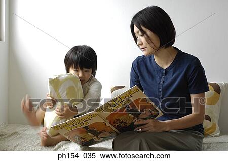 Stock Photography - Mid adult woman teaching her daughter. Fotosearch
