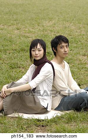 Portrait of a young couple sitting together View Large Photo Image Stock Image - Portrait of a young couple sitting together. Fotosearch