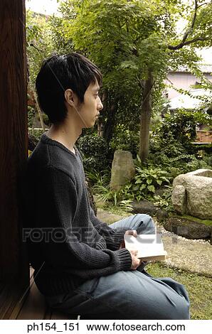 Side profile of a young man holding a book and thinking View Large Photo Image Stock Image - Side profile of a young man holding a book and thinking. Fotosearch