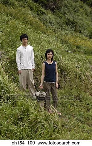 Young couple standing on a path View Large Photo Image Stock Photo - Young couple standing on a path. Fotosearch