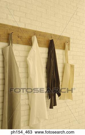 Stock Image - Close-up of clothes and bags hanging on a hanger. Fotosearch