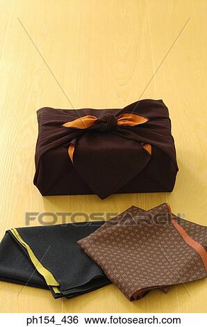 Close-up of fabric next to a wrapped package View Large Photo Image Stock Photograph - Close-up of fabric next to a wrapped package. Fotosearch