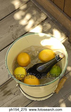 High angle view of oranges and a wine bottle in a bucket View Large Photo Image Stock Photography - High angle view of oranges and a wine bottle in a bucket. Fotosearch