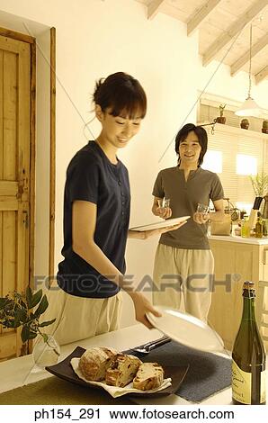 Young couple preparing for dining View Large Photo Image Stock Image - Young couple preparing for dining. Fotosearch