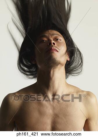 Stock Image - Shirtless man with long hair, throwing his head back. Fotosearch