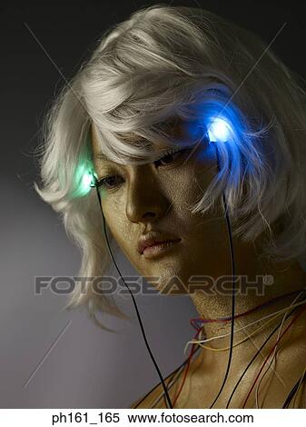 Woman wearing a blonde wig with gold paint on her face and body, and blinking headphones View Large Photo Image Stock Photography - Woman wearing a blonde wig with gold paint on her face and body, and blinking headphones . Fotosearch