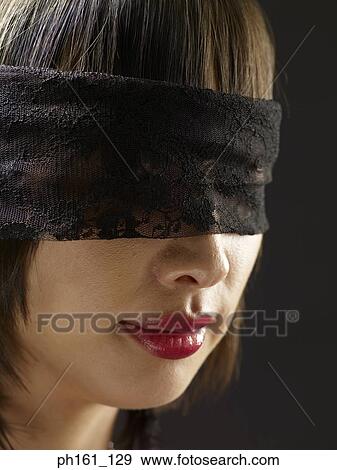 Stock Photo - Woman wearing blindfold. Fotosearch