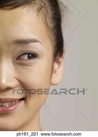 Young woman glancing sideways, smiling View Large Photo Image Stock Image - Young woman glancing sideways, smiling. Fotosearch
