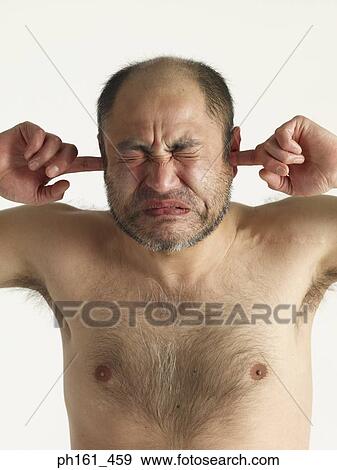 Bare chested mature man, putting fingers in ears, eyes closed, close-up View Large Photo Image Stock Photo - Bare chested mature man, putting fingers in ears, eyes closed, close-up. Fotosearch