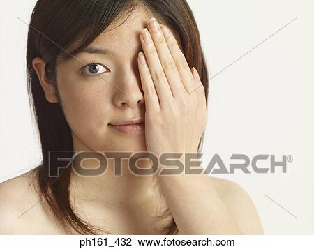 Close-up of woman covering one eye View Large Photo Image Stock Image - Close-up of woman covering one eye. Fotosearch