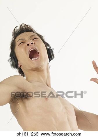Stock Image - Man with headphones, dancing, mouth open. Fotosearch