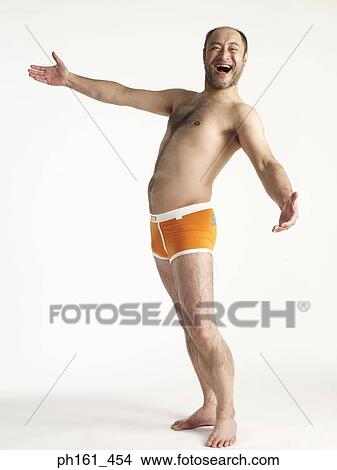 Mature man in orange briefs, laughing View Large Photo Image Picture - Mature man in orange briefs, laughing. Fotosearch
