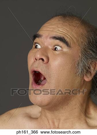 Stock Photograph - Mature man with mouth wide open. Fotosearch