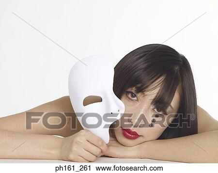 Stock Image - Portrait of a woman with red lipstick, black snowflakes and a mask. Fotosearch