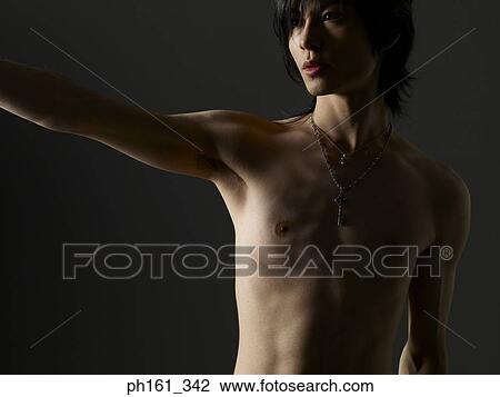 Shirtless young man pointing ahead View Large Photo Image Stock Image - Shirtless young man pointing ahead. Fotosearch