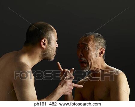 Stock Image - Two shirtless mature men, arguing. Fotosearch