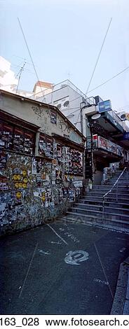 Stock Photo - Posters on wall in alley. Fotosearch