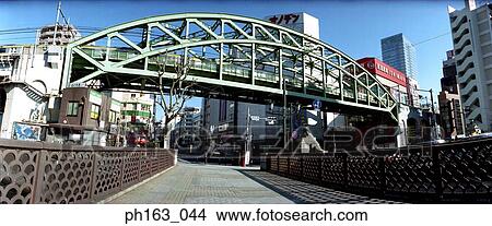 Picture - View of a railway track and pedestrian walkway on street of Japan. Fotosearch