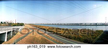 View of road surrounded by plants View Large Photo Image Stock Photo - View of road surrounded by plants. Fotosearch