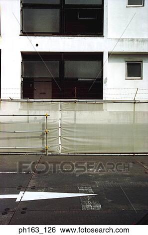 Stock Photograph - Road next to a building. Fotosearch