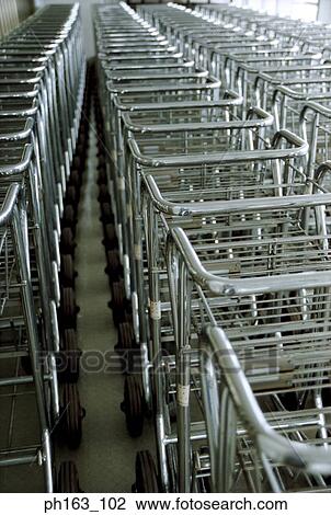 Stock Image - Rows of baggage trolley. Fotosearch