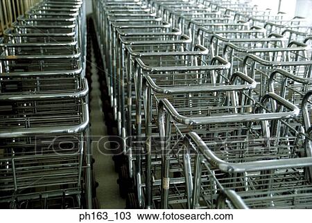 Stock Image - Rows of baggage trolley. Fotosearch