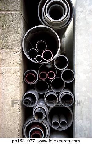 Stack of pipes in different sizes View Large Photo Image Stock Photo - Stack of pipes in different sizes. Fotosearch