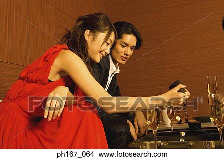 Picture - A couple playing backgammon. Fotosearch