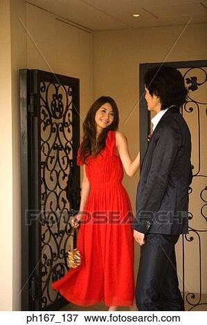 A couple standing by iron gate View Large Photo Image Stock Photo - A couple standing by iron gate. Fotosearch