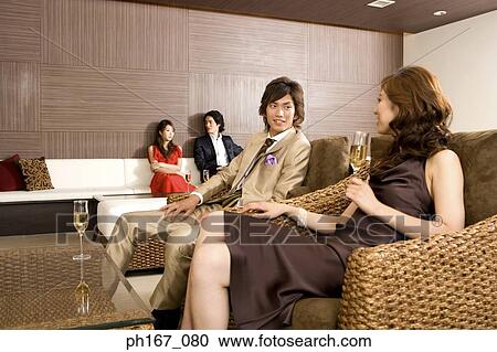 A couple with others, relaxing View Large Photo Image Stock Image - A couple with others, relaxing. Fotosearch