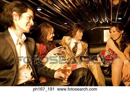 Two couples having wine and champagne inside a limousine View Large Photo Image Stock Image - Two couples having wine and champagne inside a limousine. Fotosearch