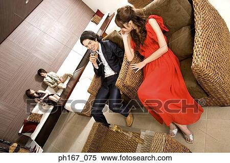 Two couples relaxing in a house, high angle view View Large Photo Image Stock Photography - Two couples relaxing in a house, high angle view. Fotosearch