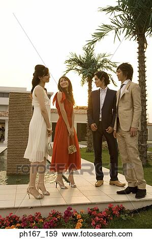 Stock Photo - Two couples standing in the courtyard. Fotosearch