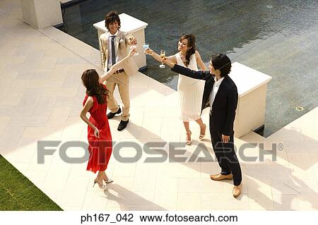 Two couples toasting, high angle View Large Photo Image Stock Image - Two couples toasting, high angle. Fotosearch