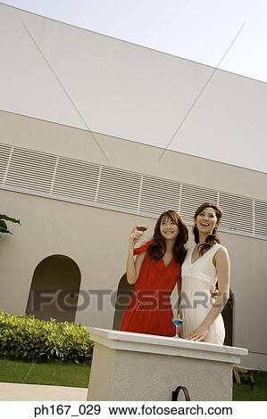 Two women having cocktails, outdoors View Large Photo Image Stock Photo - Two women having cocktails, outdoors. Fotosearch