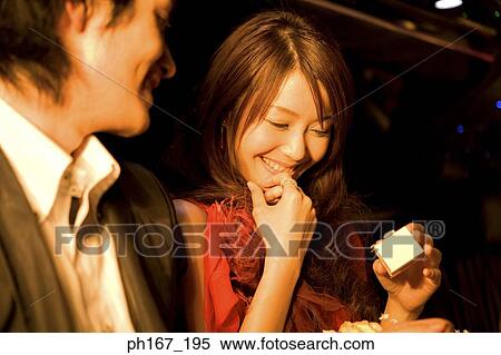 Young man with woman holding a gift View Large Photo Image Stock Photography - Young man with woman holding a gift. Fotosearch