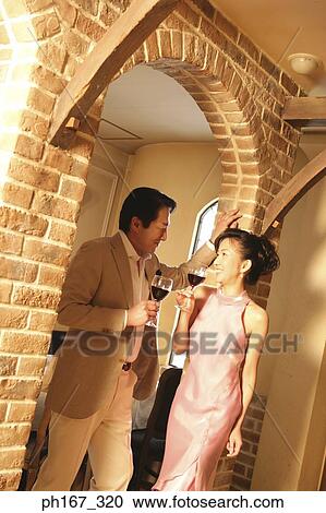 A couple relaxing over a glass of wine View Large Photo Image Stock Image - A couple relaxing over a glass of wine. Fotosearch