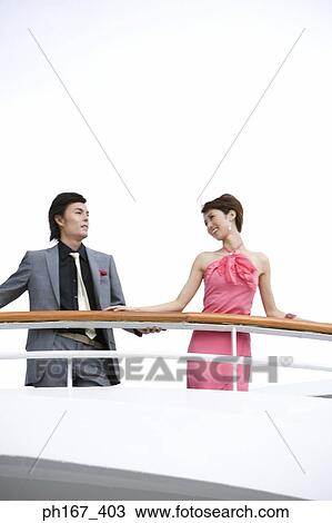 A couple standing by the railings of a cruise ship View Large Photo Image Stock Image - A couple standing by the railings of a cruise ship. Fotosearch