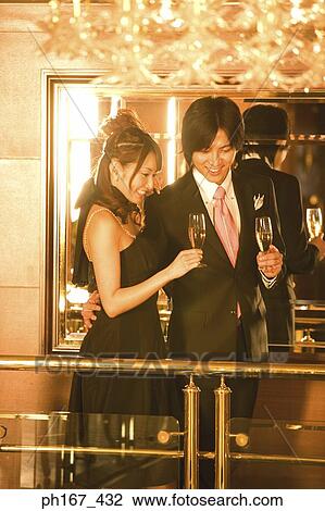Stock Image - Couple relaxing by bar in cruise ship. Fotosearch