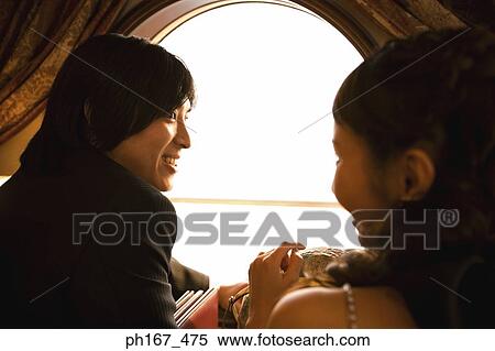 Stock Photography - Couple standing by the window, rear view. Fotosearch