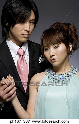 Stock Photo - Portrait of a couple holding hands. Fotosearch