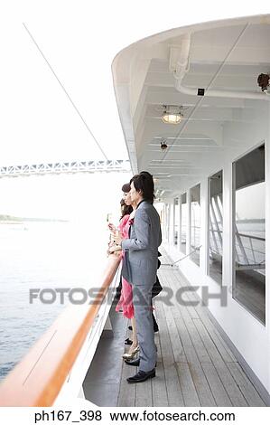 Two couple enjoying the view onboard a cruise ship View Large Photo Image Stock Photo - Two couple enjoying the view onboard a cruise ship. Fotosearch