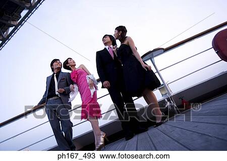 Two couples enjoying the view on cruise ship View Large Photo Image Stock Image - Two couples enjoying the view on cruise ship. Fotosearch