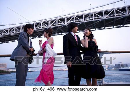 Two couples enjoying the view on cruise ship View Large Photo Image Stock Photograph - Two couples enjoying the view on cruise ship. Fotosearch