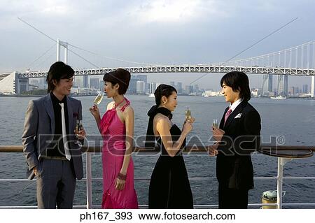 Stock Image - Two couples enjoying the view onboard a cruise ship. Fotosearch
