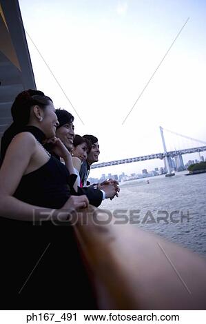 Two couples enjoying the view onboard a cruise ship View Large Photo Image Stock Image - Two couples enjoying the view onboard a cruise ship. Fotosearch