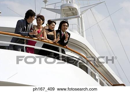 Stock Photo - Two couples enjoying the view onboard a cruise ship. Fotosearch